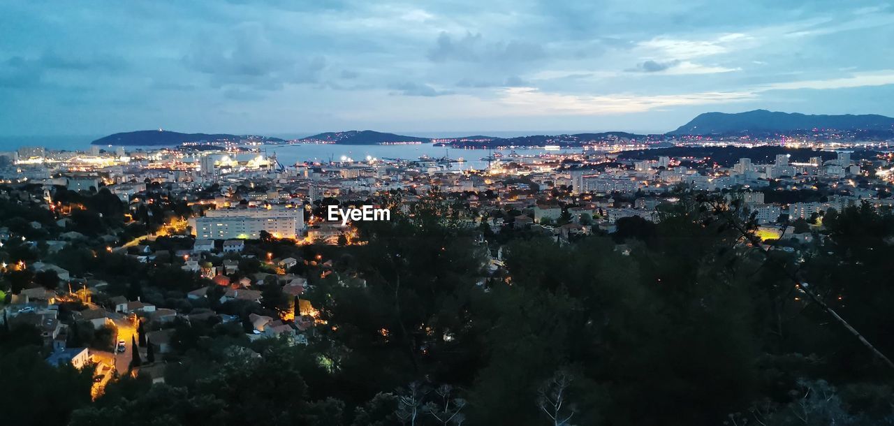 High angle view of illuminated buildings in city against sky