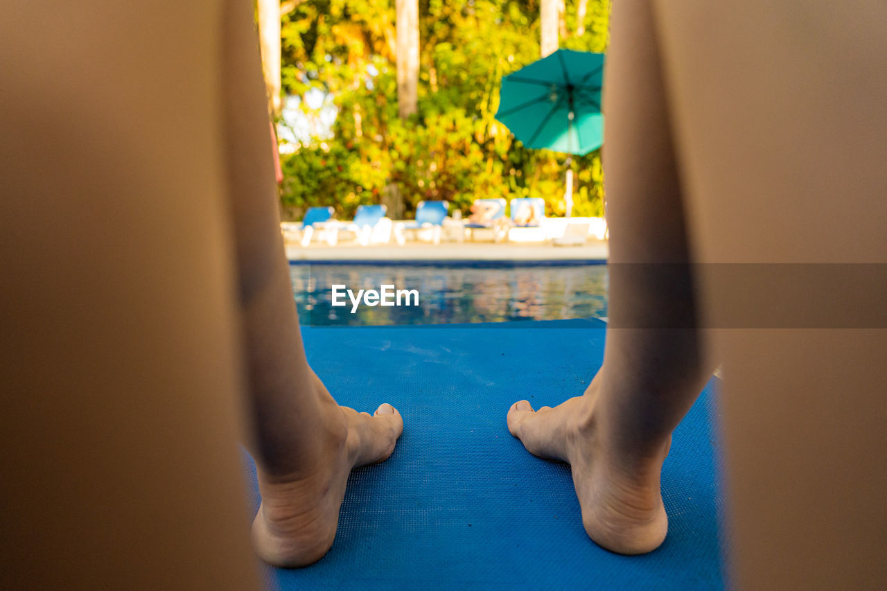 Low section of woman at swimming pool