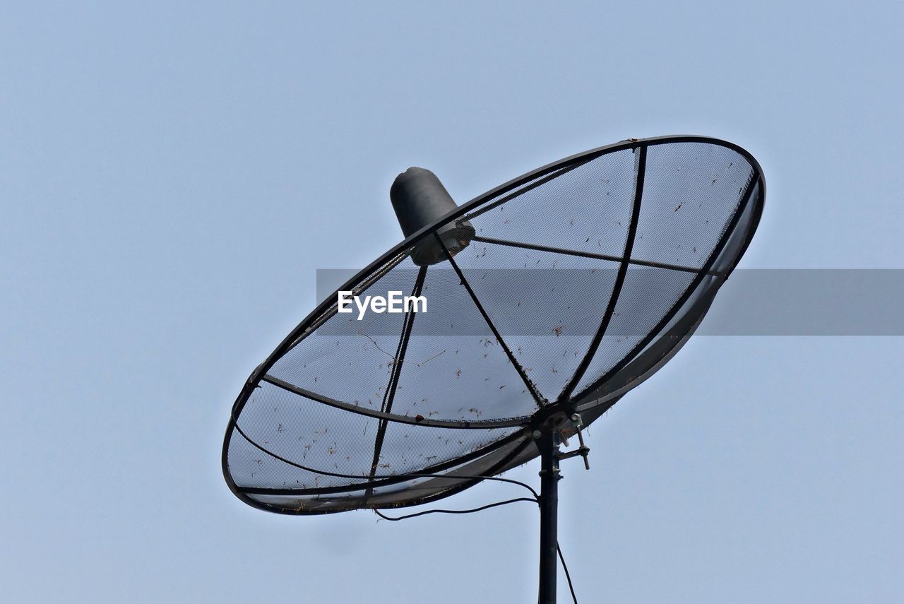 Low angle view of satellite dish against clear blue sky