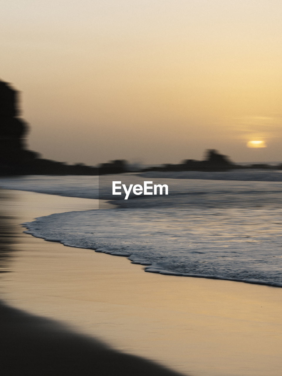 sky, sunset, water, sea, scenics - nature, land, beauty in nature, nature, tranquility, beach, tranquil scene, dawn, reflection, ocean, sand, wave, no people, horizon, coast, shore, idyllic, sunlight, environment, outdoors, motion, landscape, travel destinations, body of water, evening, sun, non-urban scene, clear sky, horizon over water