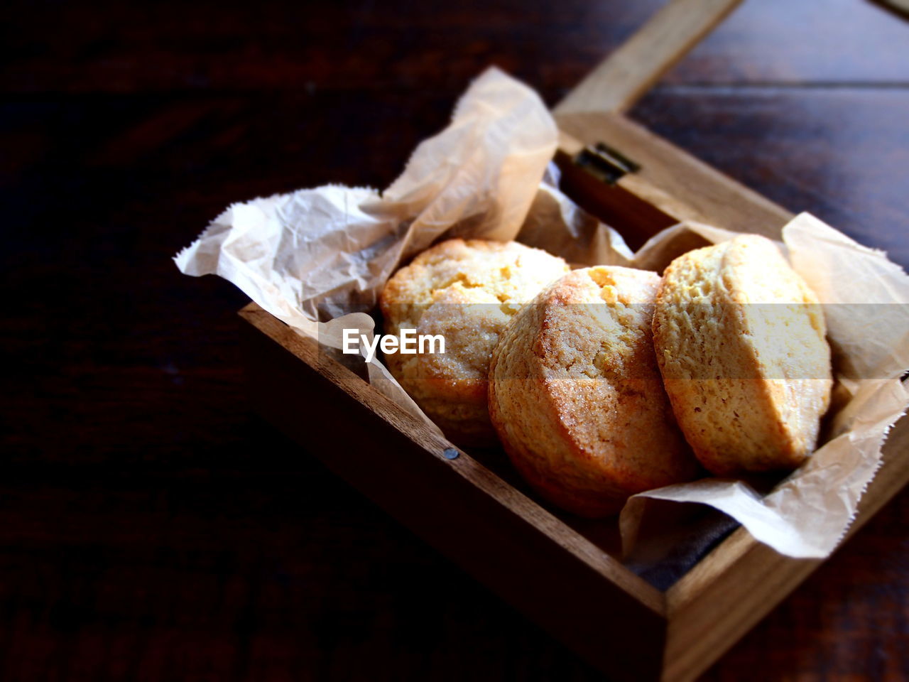 Close-up of lemon scones in wooden box on table