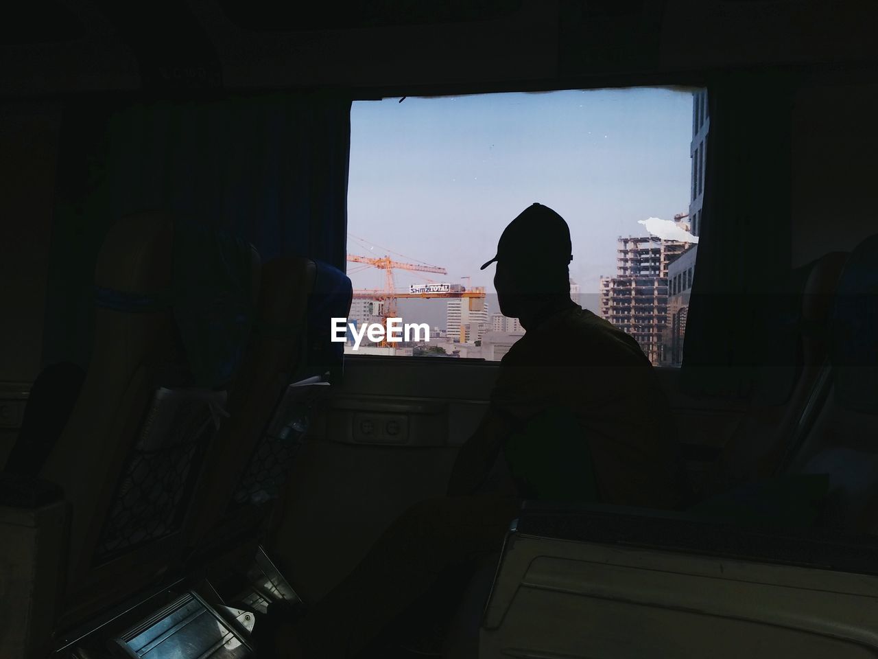 Man looking through bus window