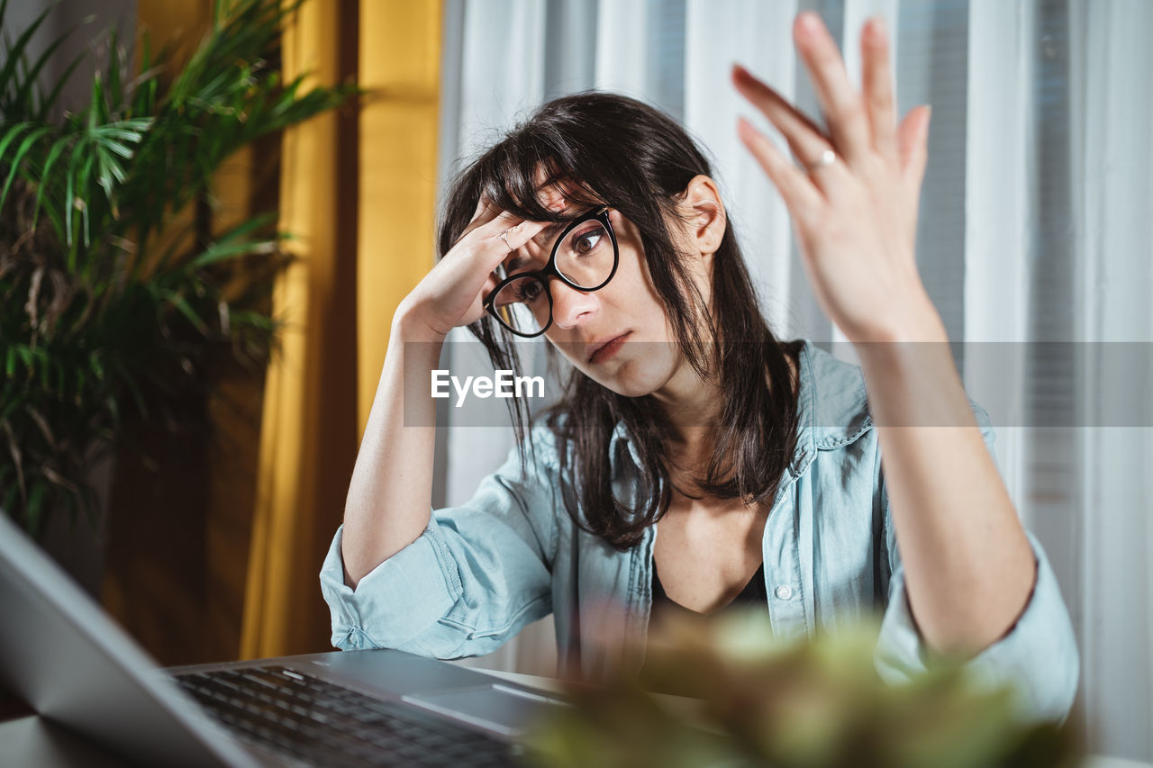 Exhausted businesswoman sitting at home