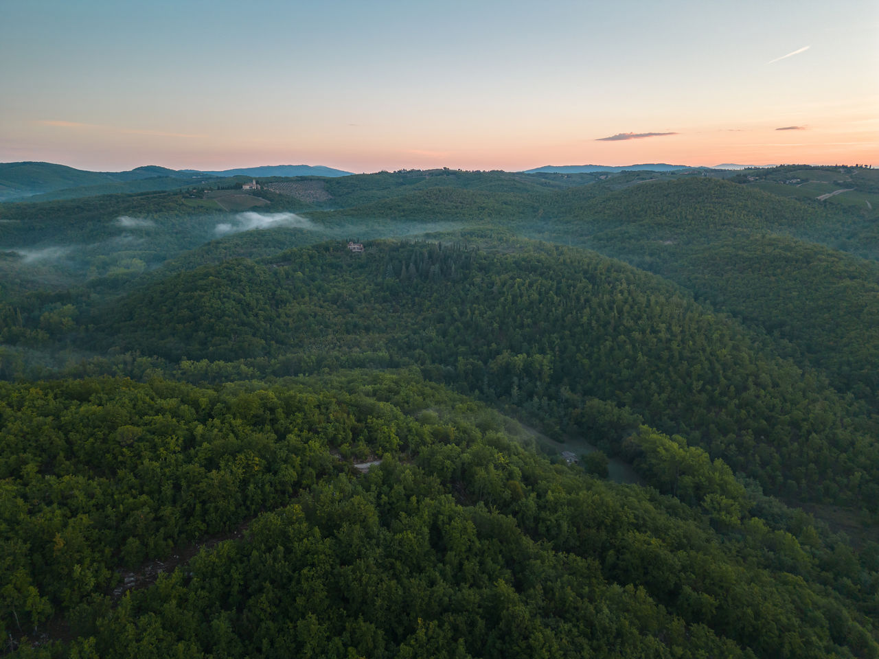 High angle view of tuscany landscape against sky during sunrise