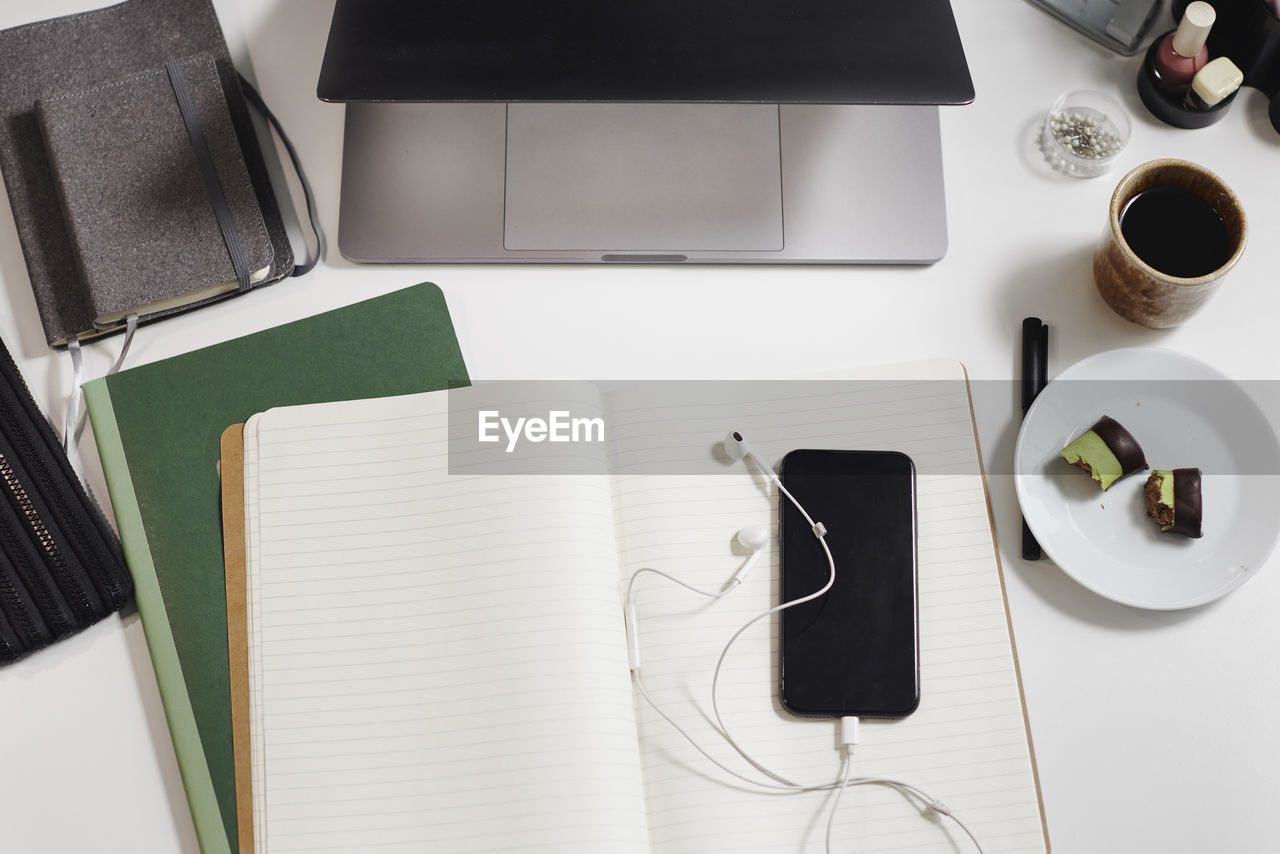 View of desk with diary and cell phone