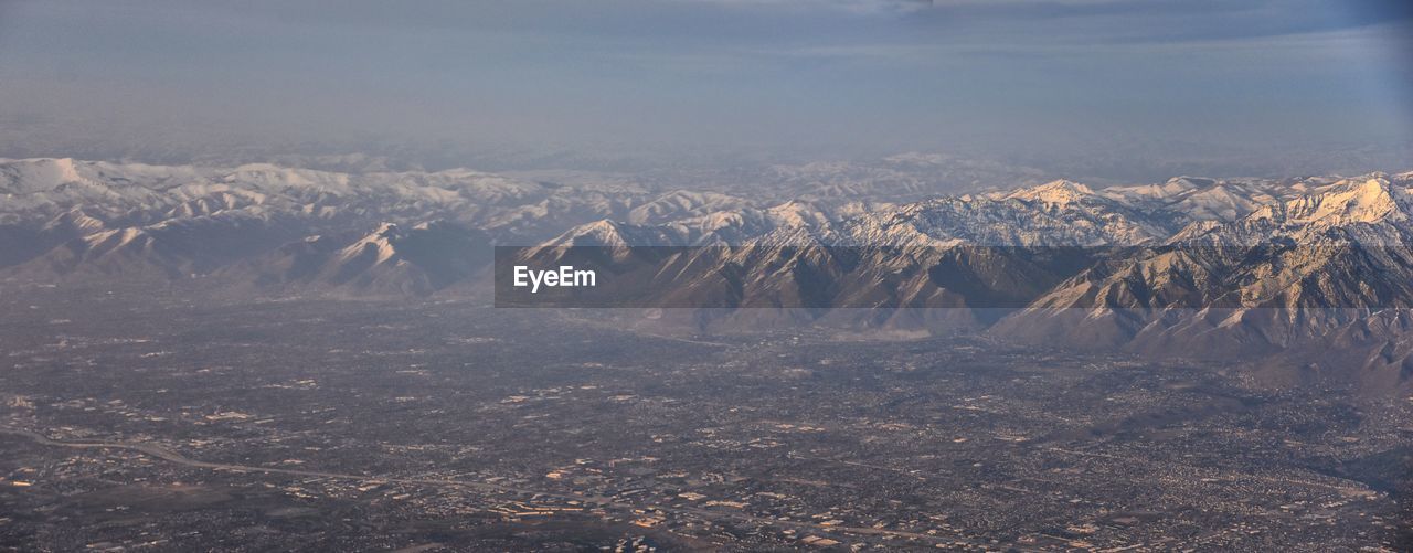 AERIAL VIEW OF DRAMATIC LANDSCAPE AGAINST SKY