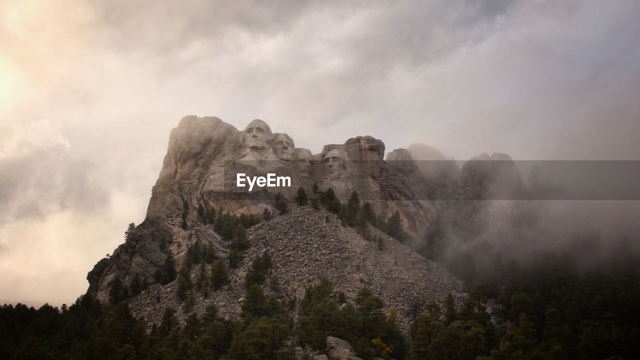 Low angle view of rocks against sky