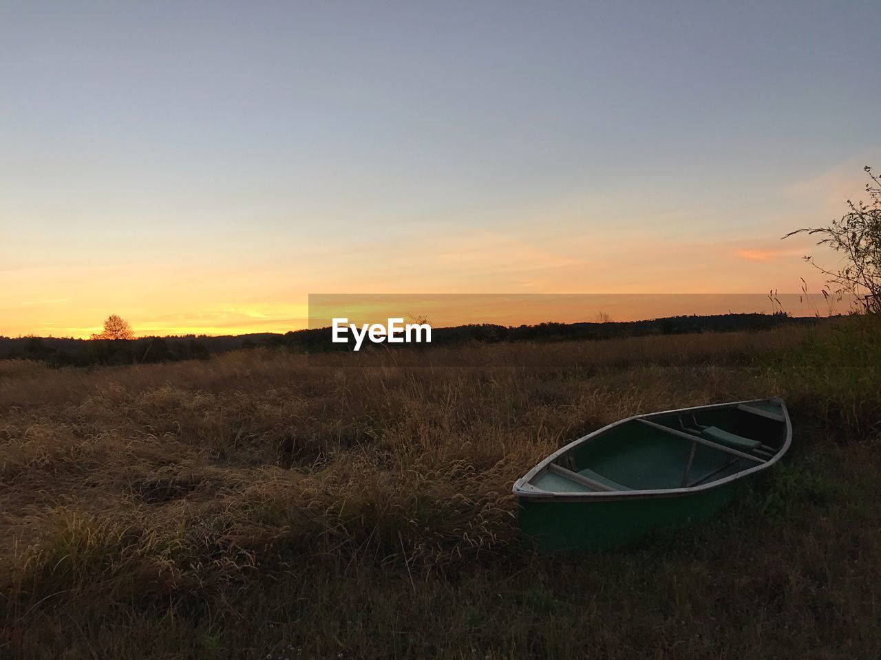 VIEW OF FIELD AGAINST SKY AT SUNSET