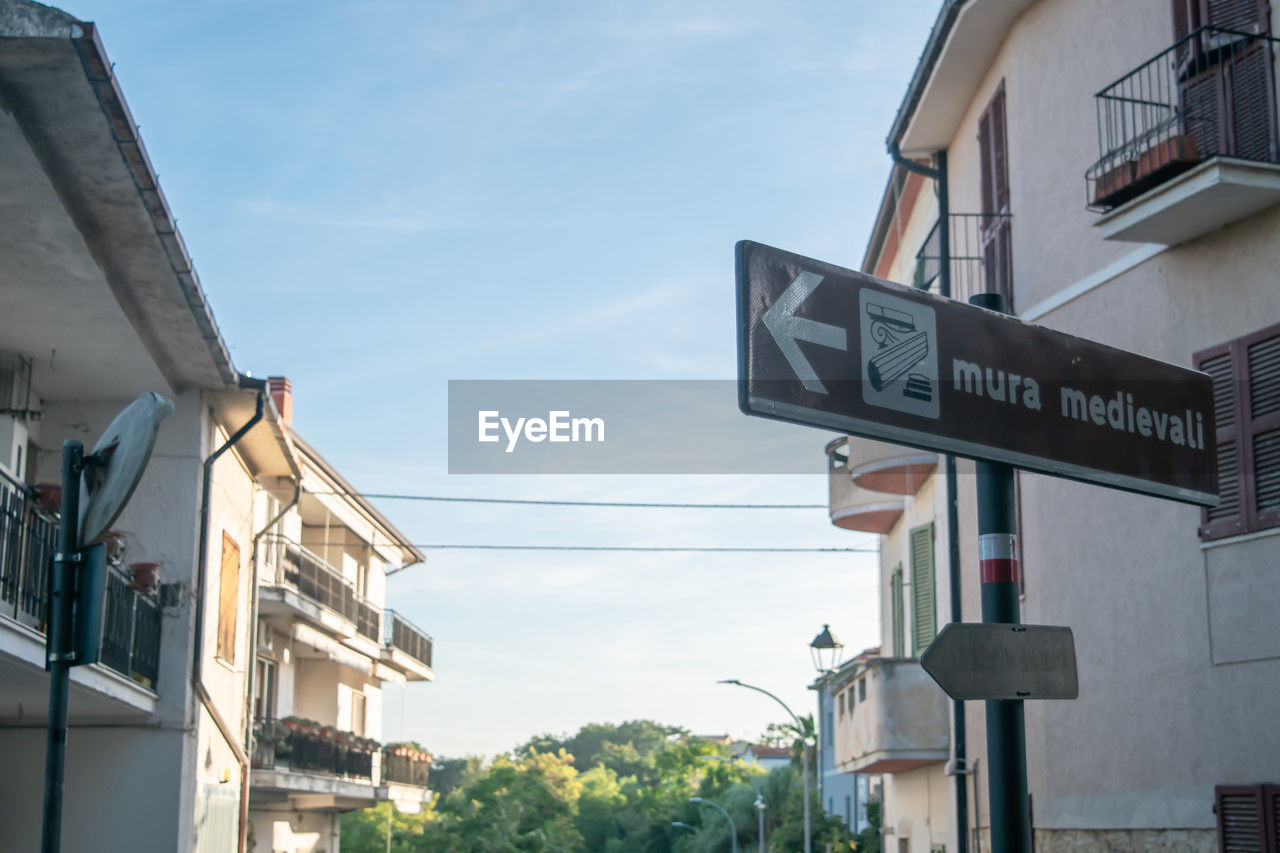 Low angle view of road sign against sky