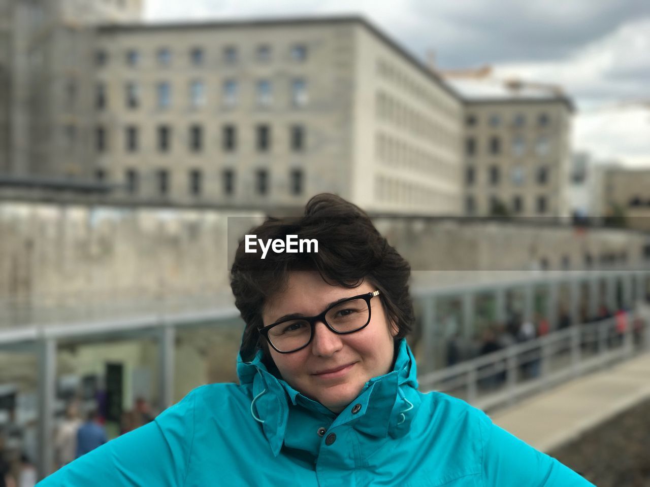 Portrait of woman against buildings in city