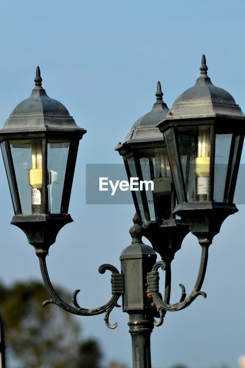 LOW ANGLE VIEW OF STREET LIGHTS AGAINST CLEAR SKY