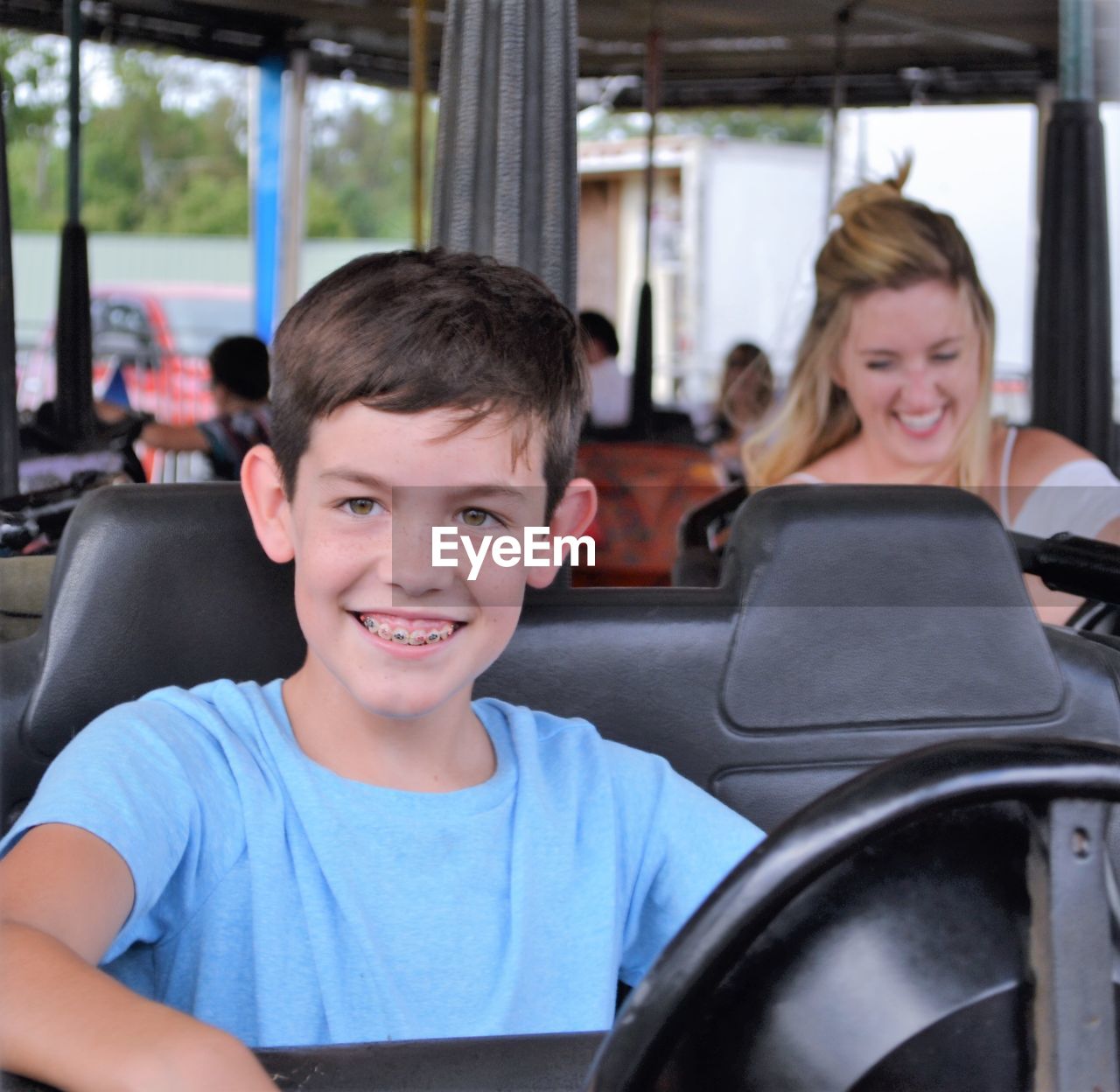 Smiling boy sitting in bumper car