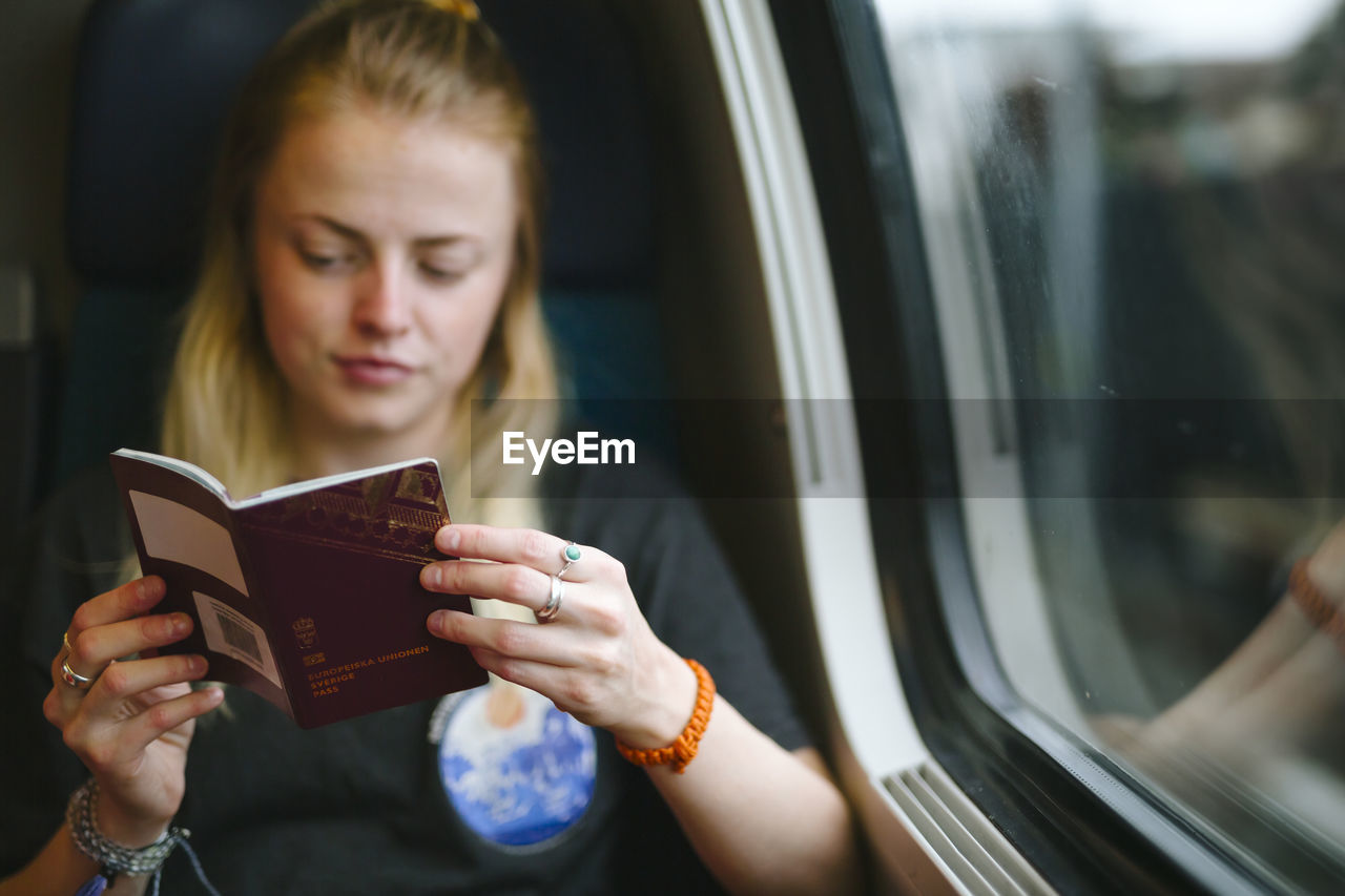 Woman holding passport in train