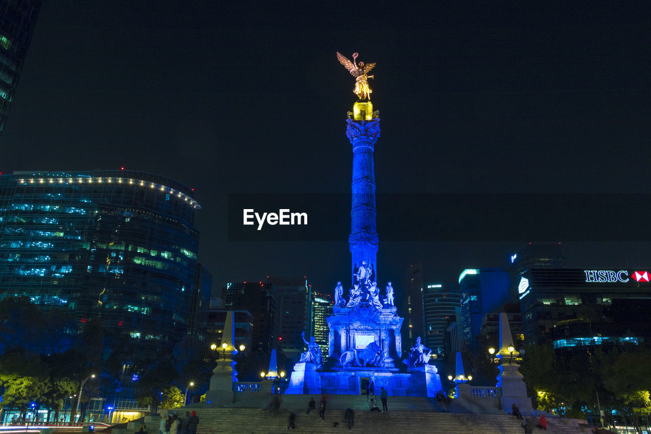 ILLUMINATED STATUE OF CITY AT NIGHT