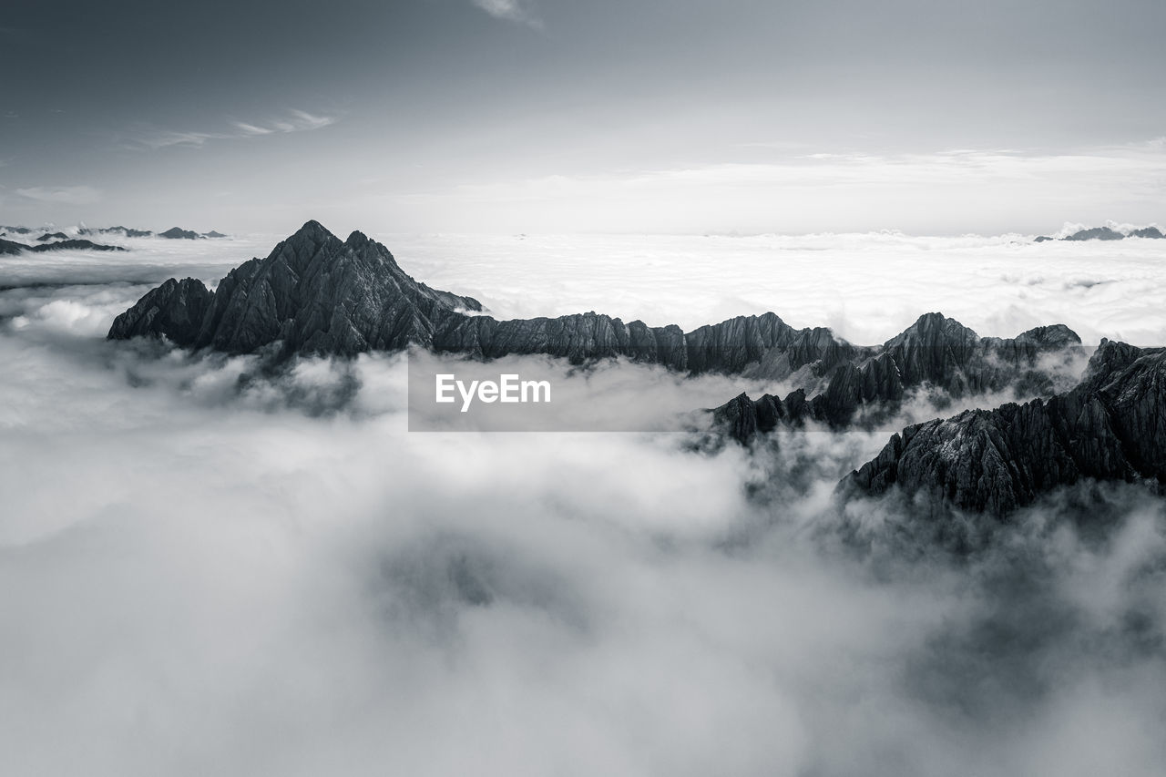 Mountain peaks rising above a sea of clouds, lienz, austria.