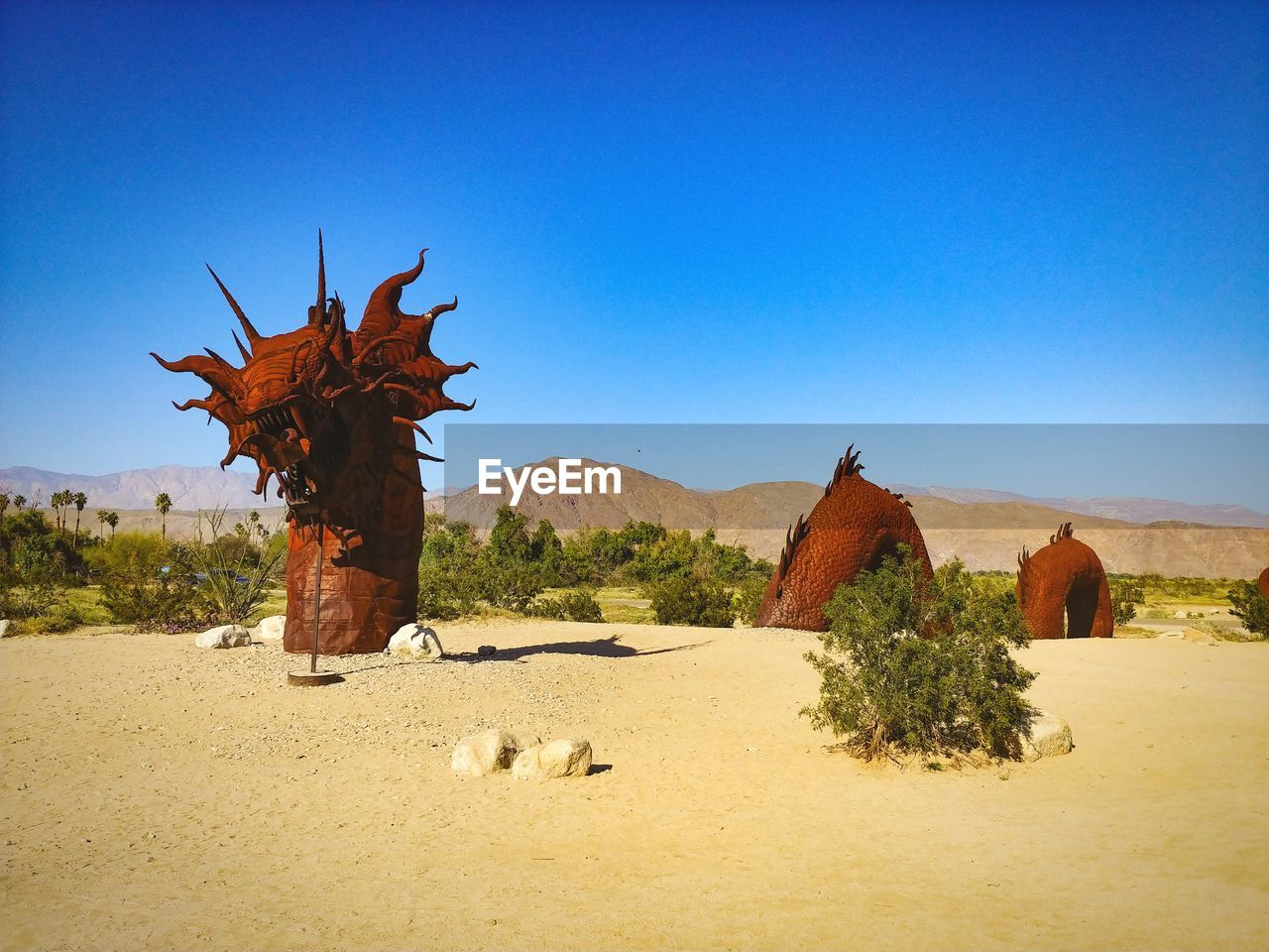 Scenic view of desert against clear blue sky, serpent sculpture, anza borrego 