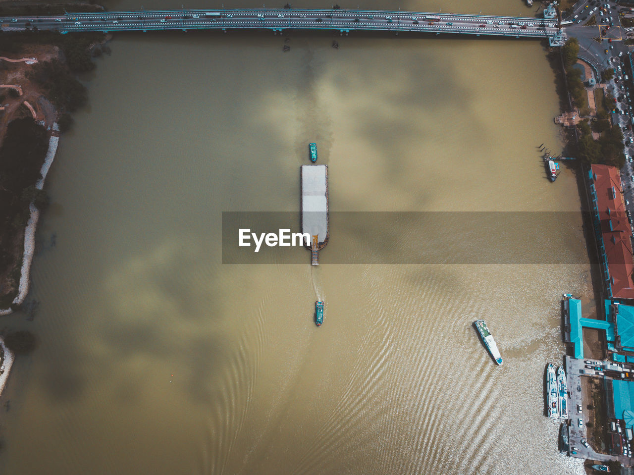 Aerial view of ships sailing in river at city
