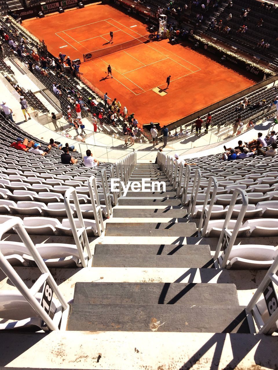 Spectators watching tennis in stadium