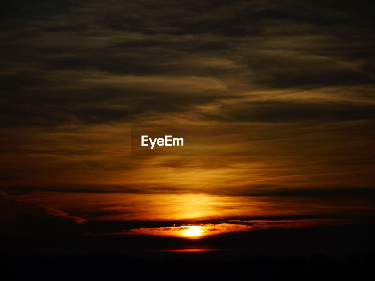 Scenic view of dramatic sky over sea during sunset
