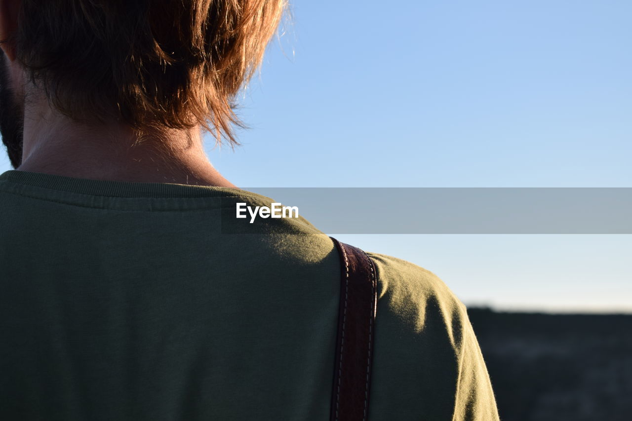 Rear view of man against clear sky