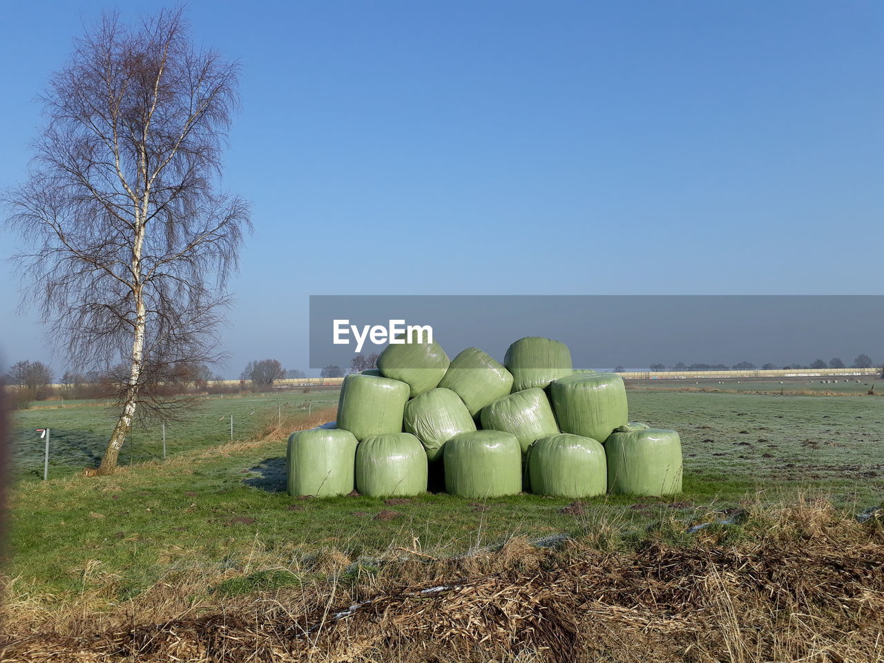 STACK OF HAY ON FIELD AGAINST SKY