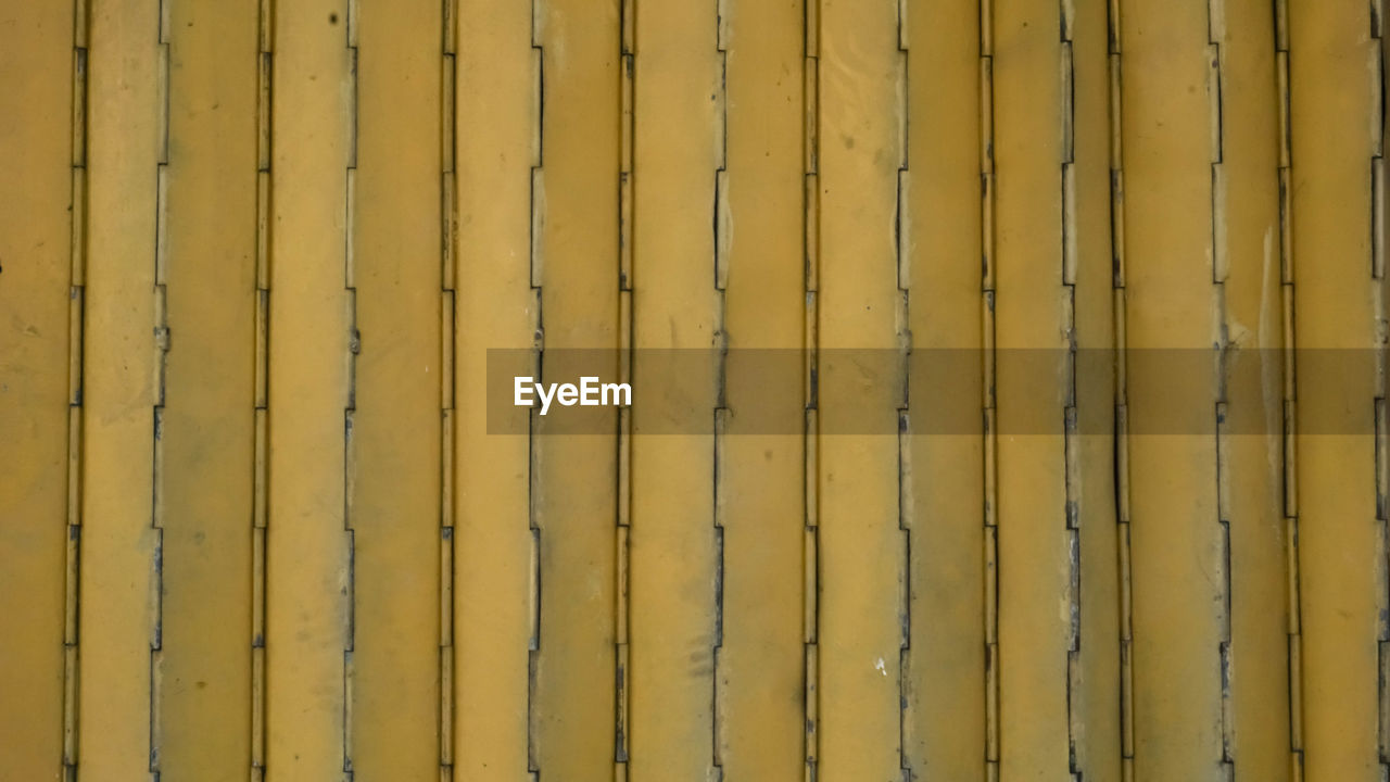 FULL FRAME SHOT OF YELLOW METAL WALL