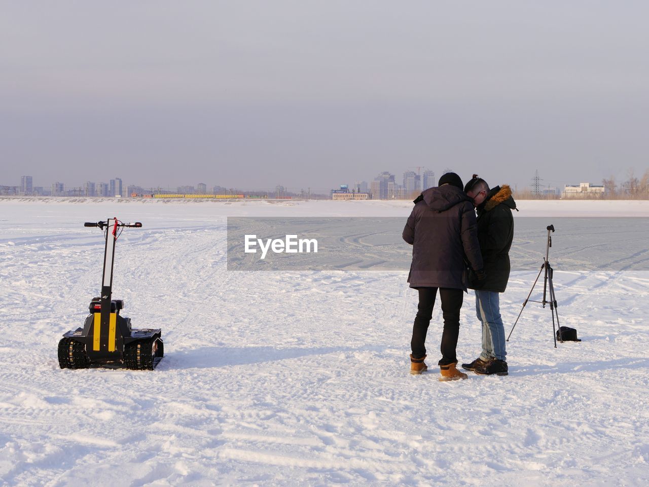 Two men standing on snow covered