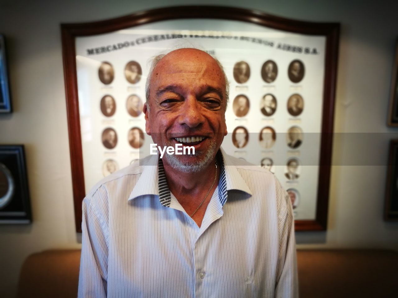 Portrait of smiling man against wall