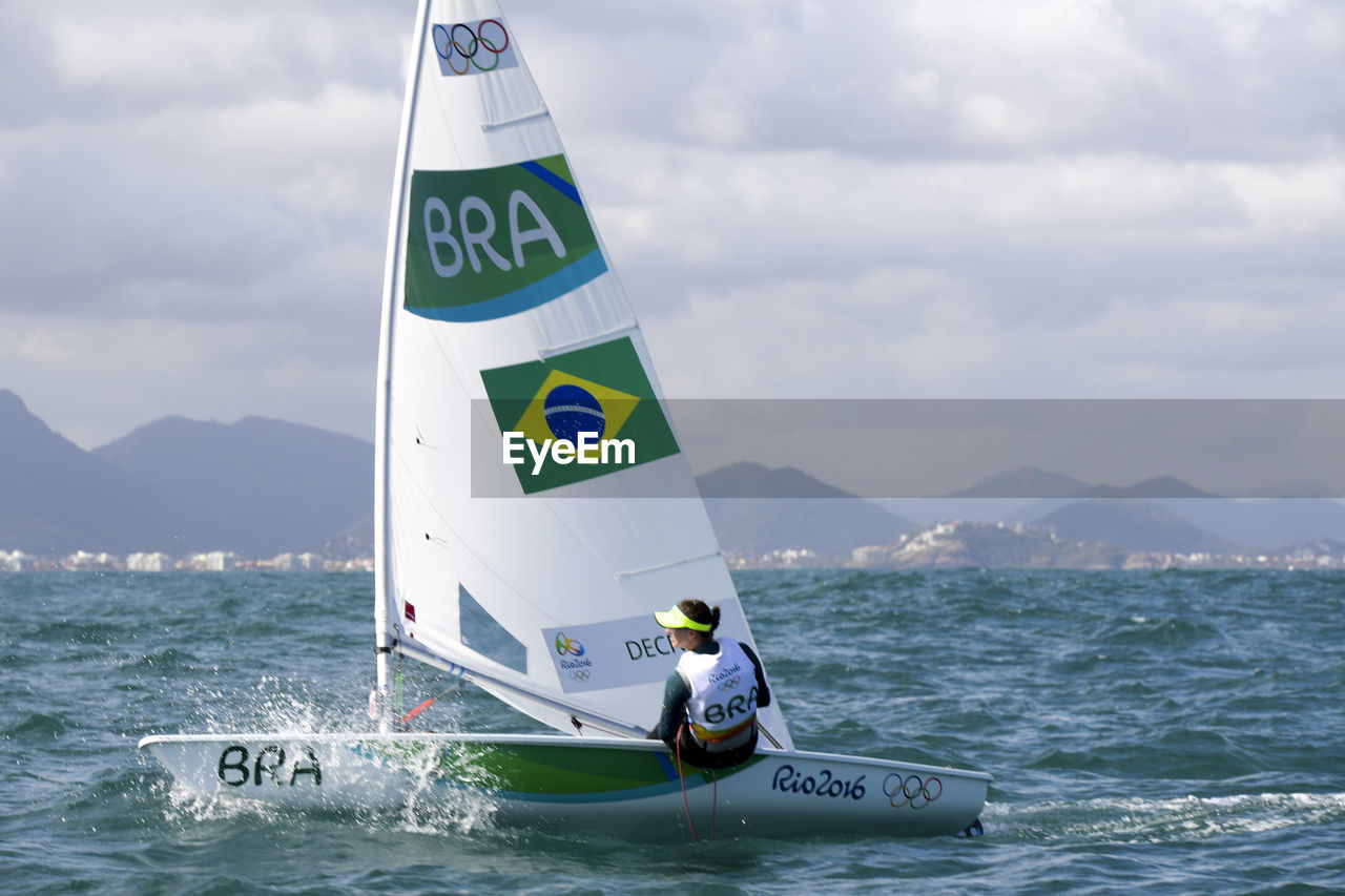 MAN IN SEA AGAINST SKY