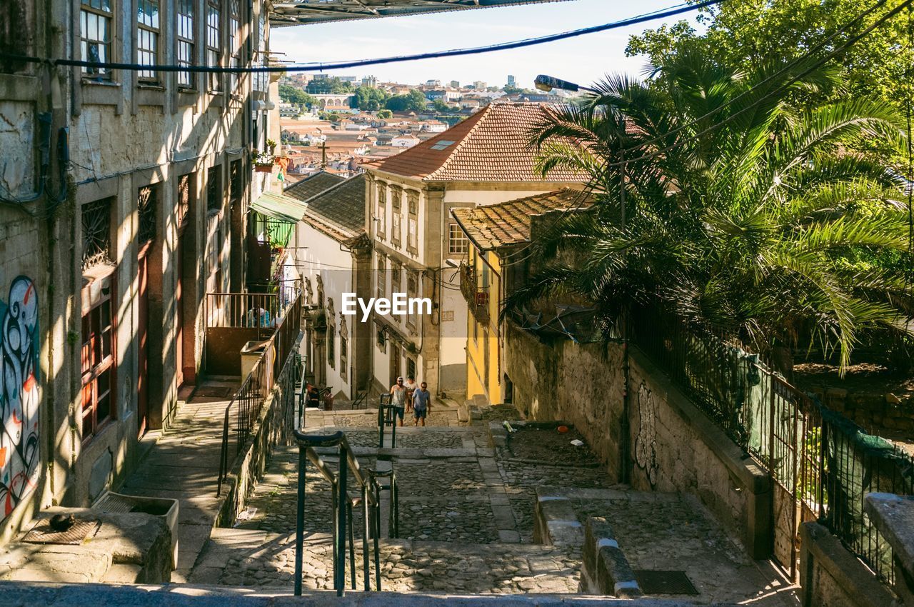 High angle view of men walking on pathway amidst buildings