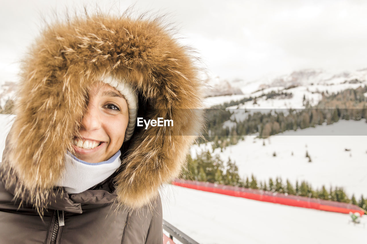 Portrait of smiling young woman in warm clothes