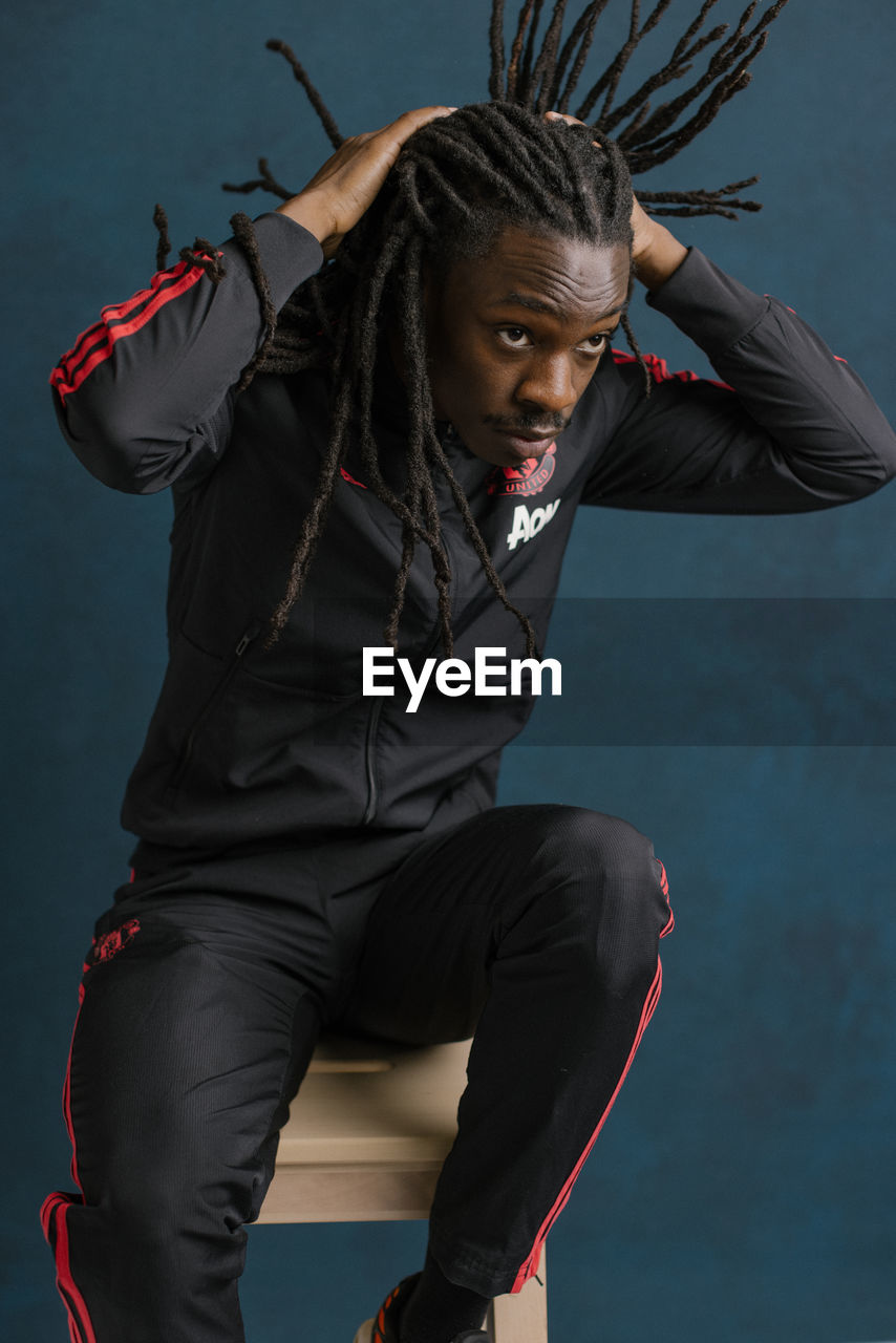 Portrait of young man with dreadlocks 