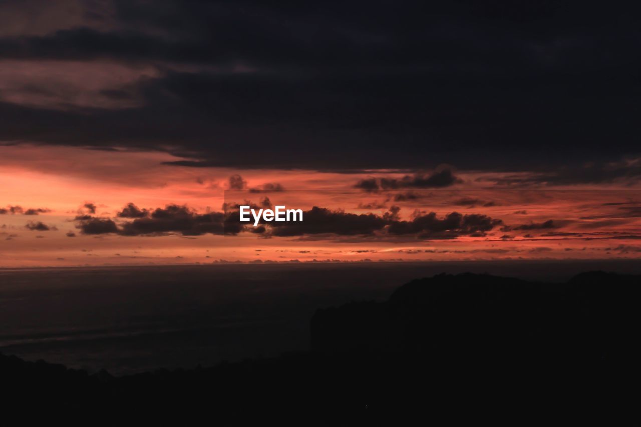 Scenic view of dramatic sky during sunset