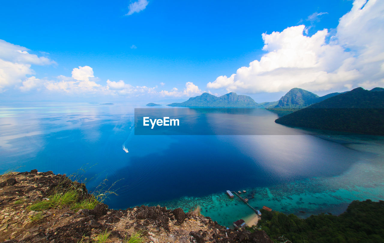 Panoramic view of sea against blue sky