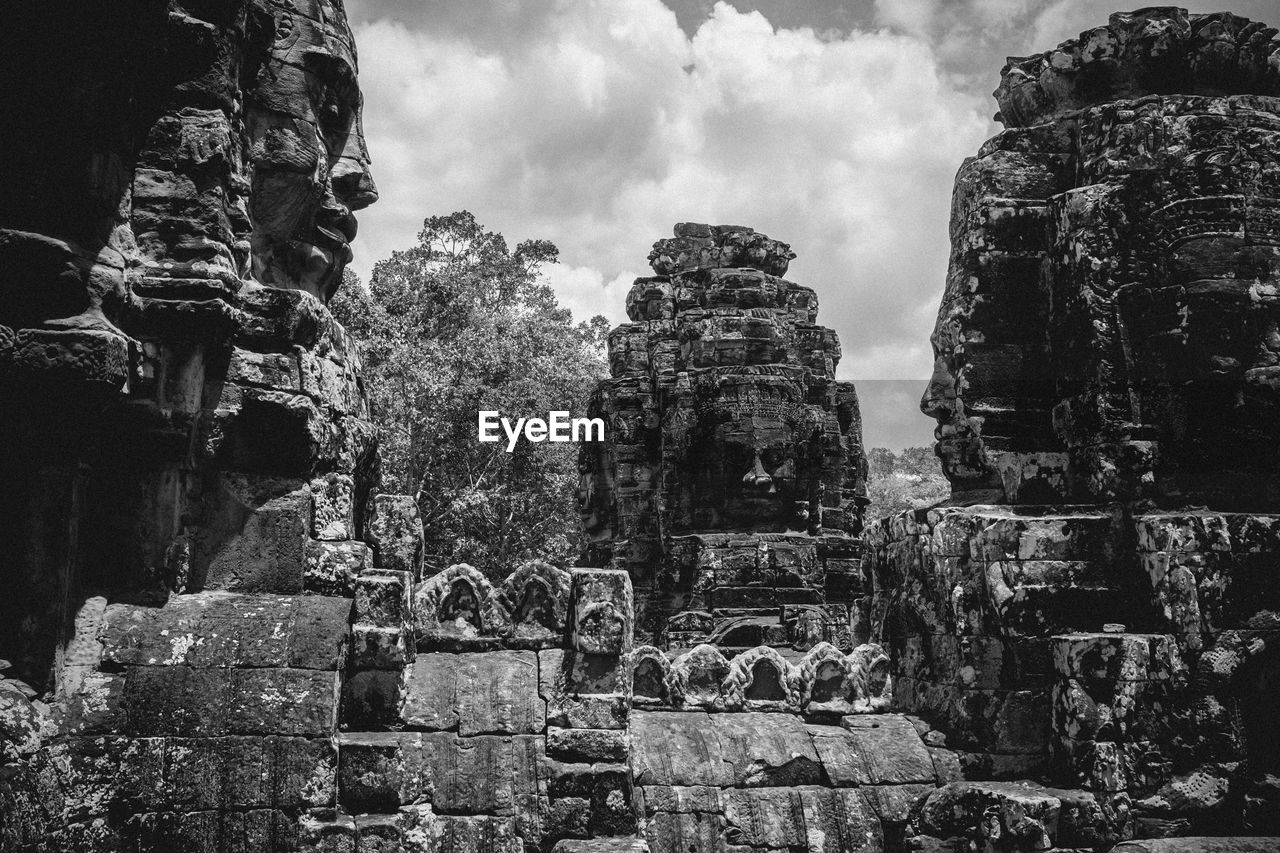 Ruins of angkor wat temple against cloudy sky