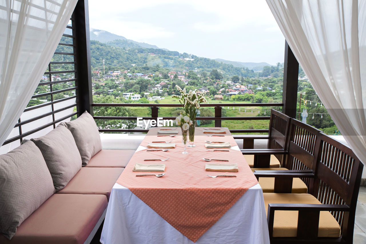 Empty chairs and tables in balcony