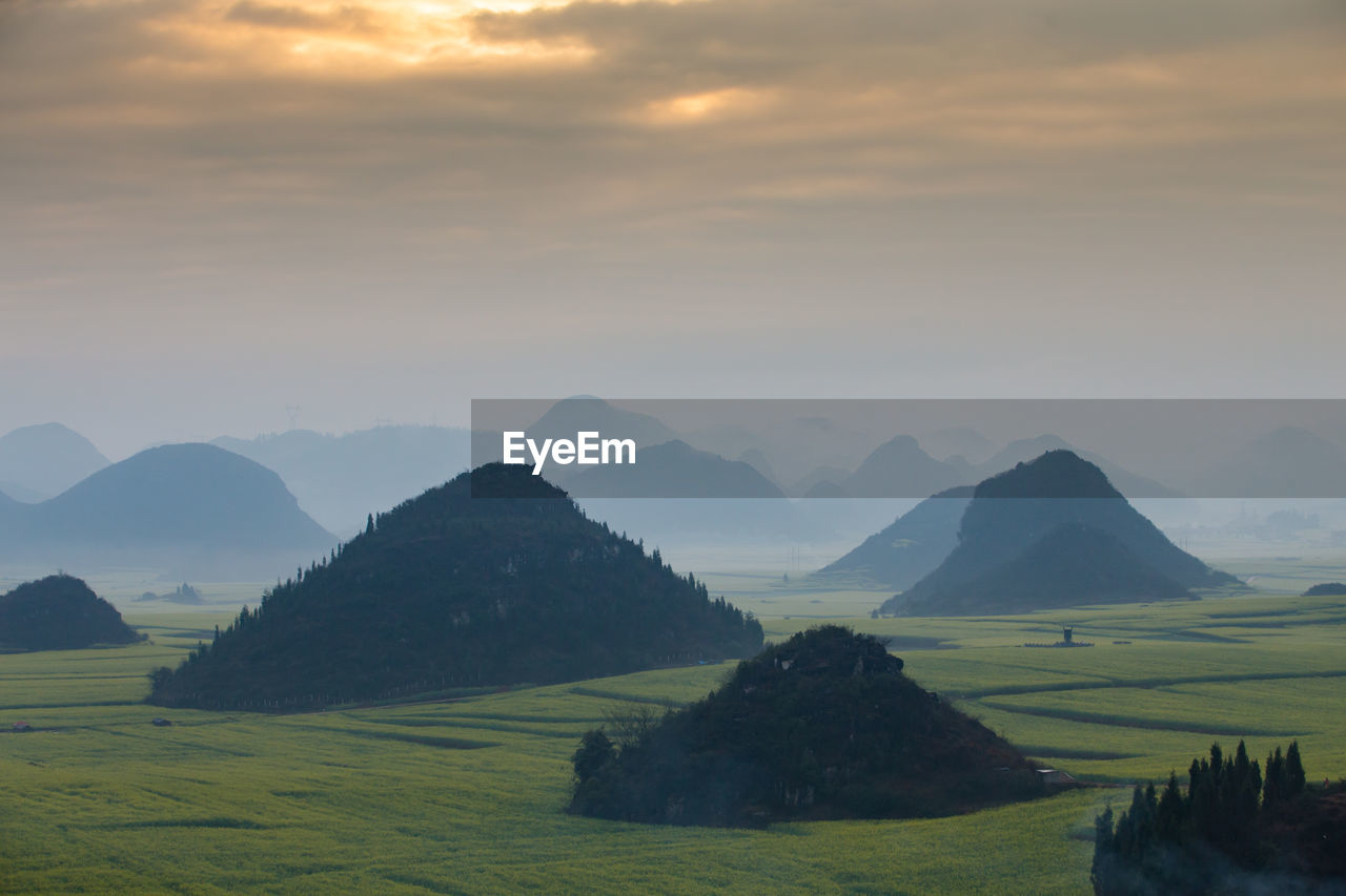 SCENIC VIEW OF FIELD AND MOUNTAINS AGAINST SKY