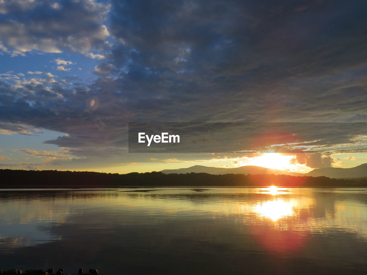 SCENIC VIEW OF LAKE BY SILHOUETTE TREES AGAINST SKY