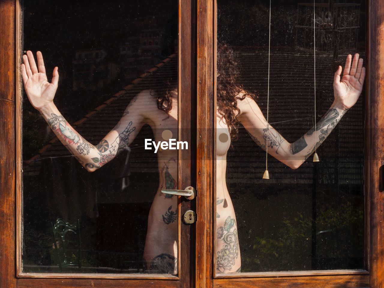 Naked woman seen through window