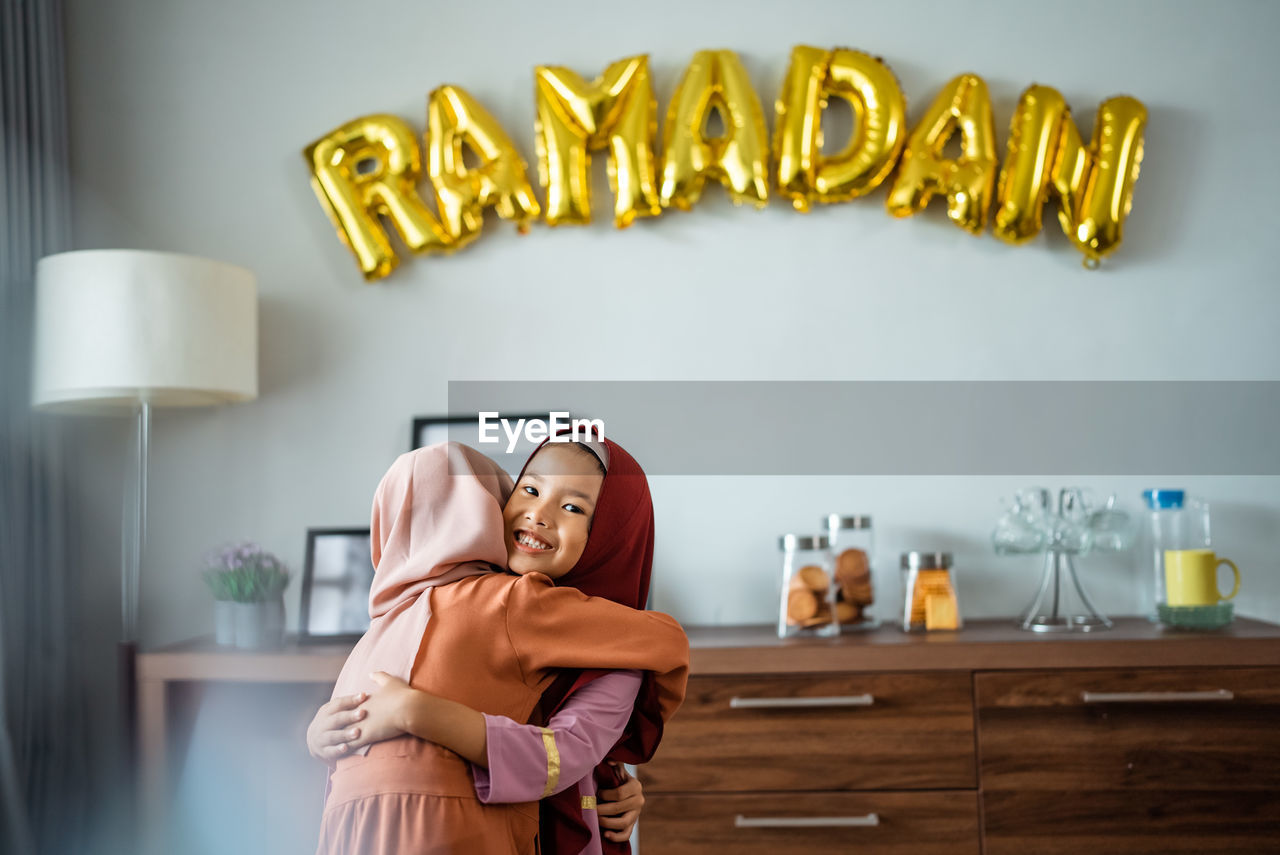 Cute girl wishing eid to each other at home