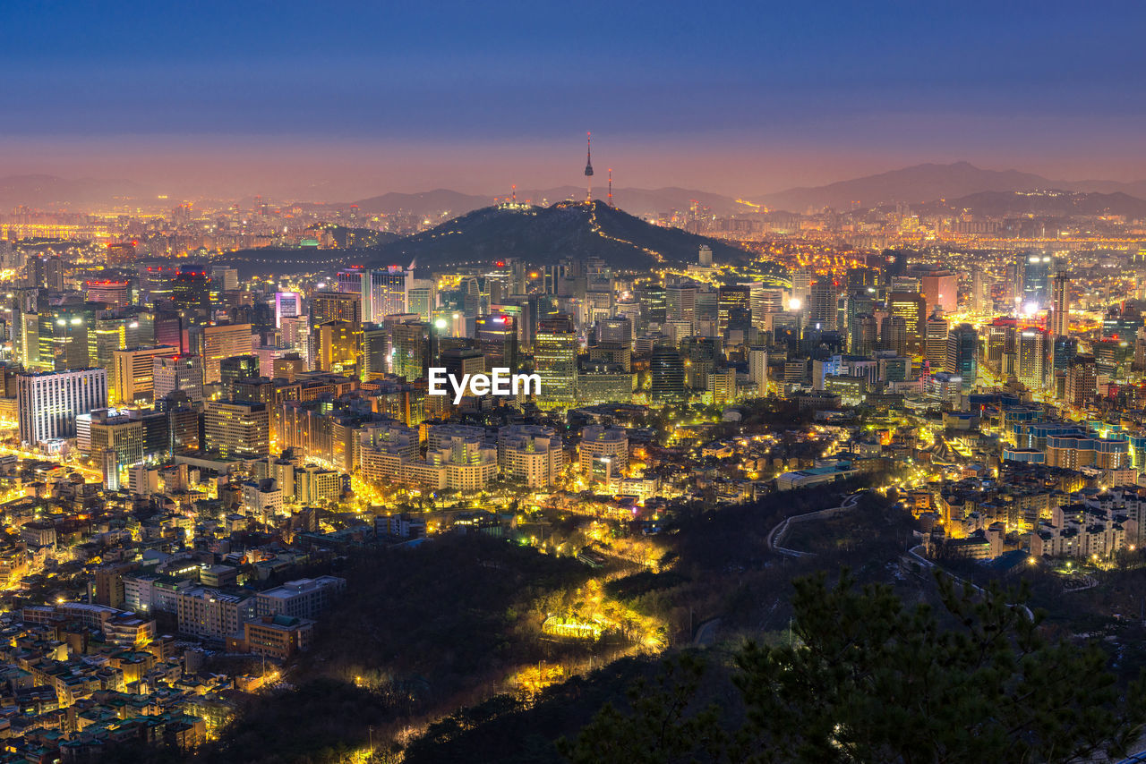 Aerial view of city lit up at night