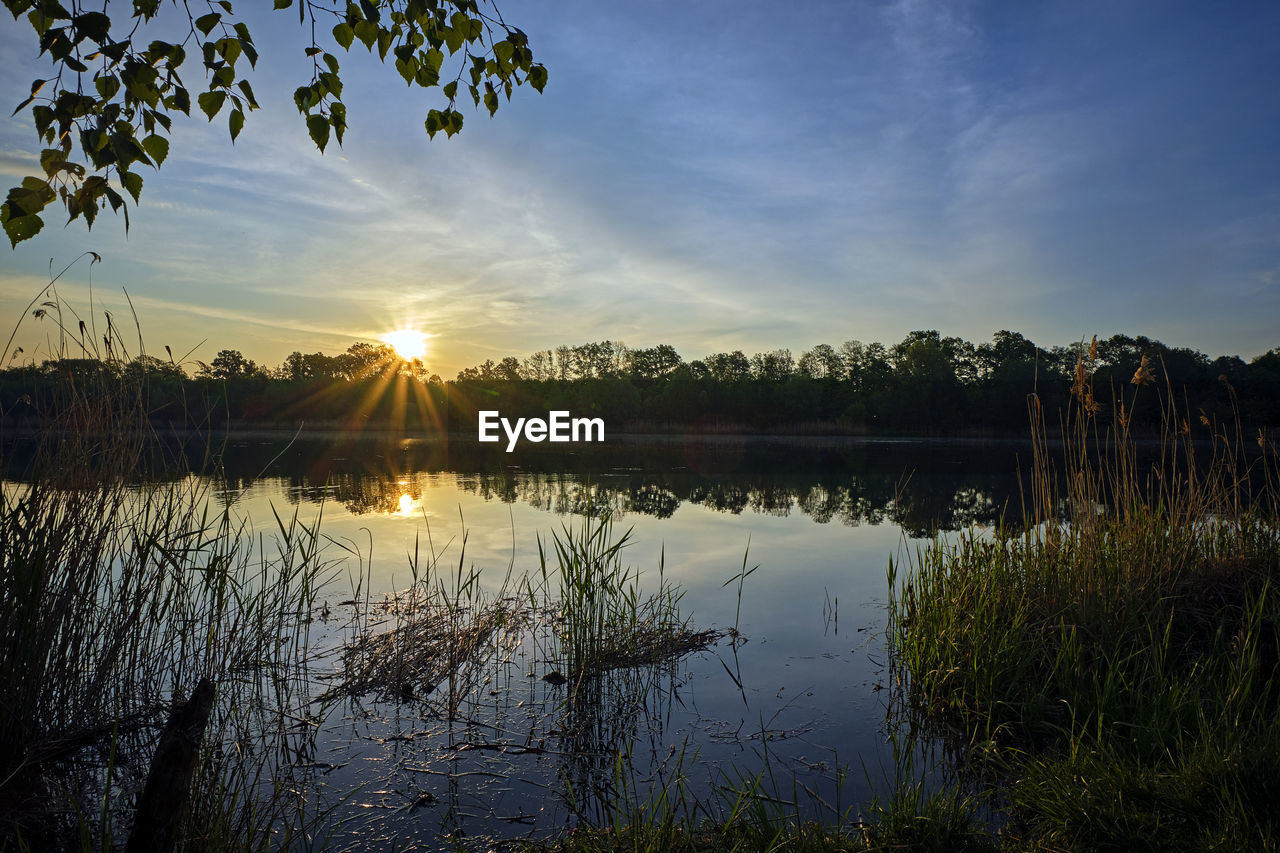 Scenic view of lake against sky during sunset