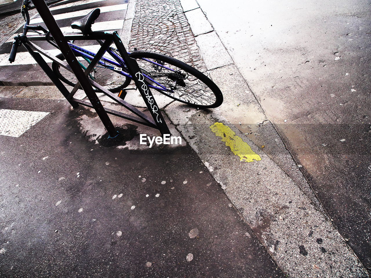 CLOSE-UP OF BICYCLE ON SIDEWALK