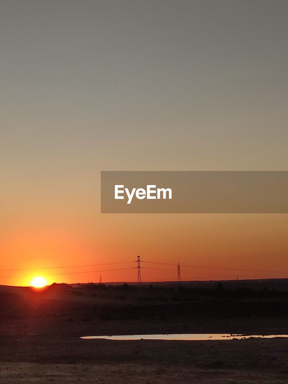 SILHOUETTE LANDSCAPE AGAINST CLEAR SKY DURING SUNSET