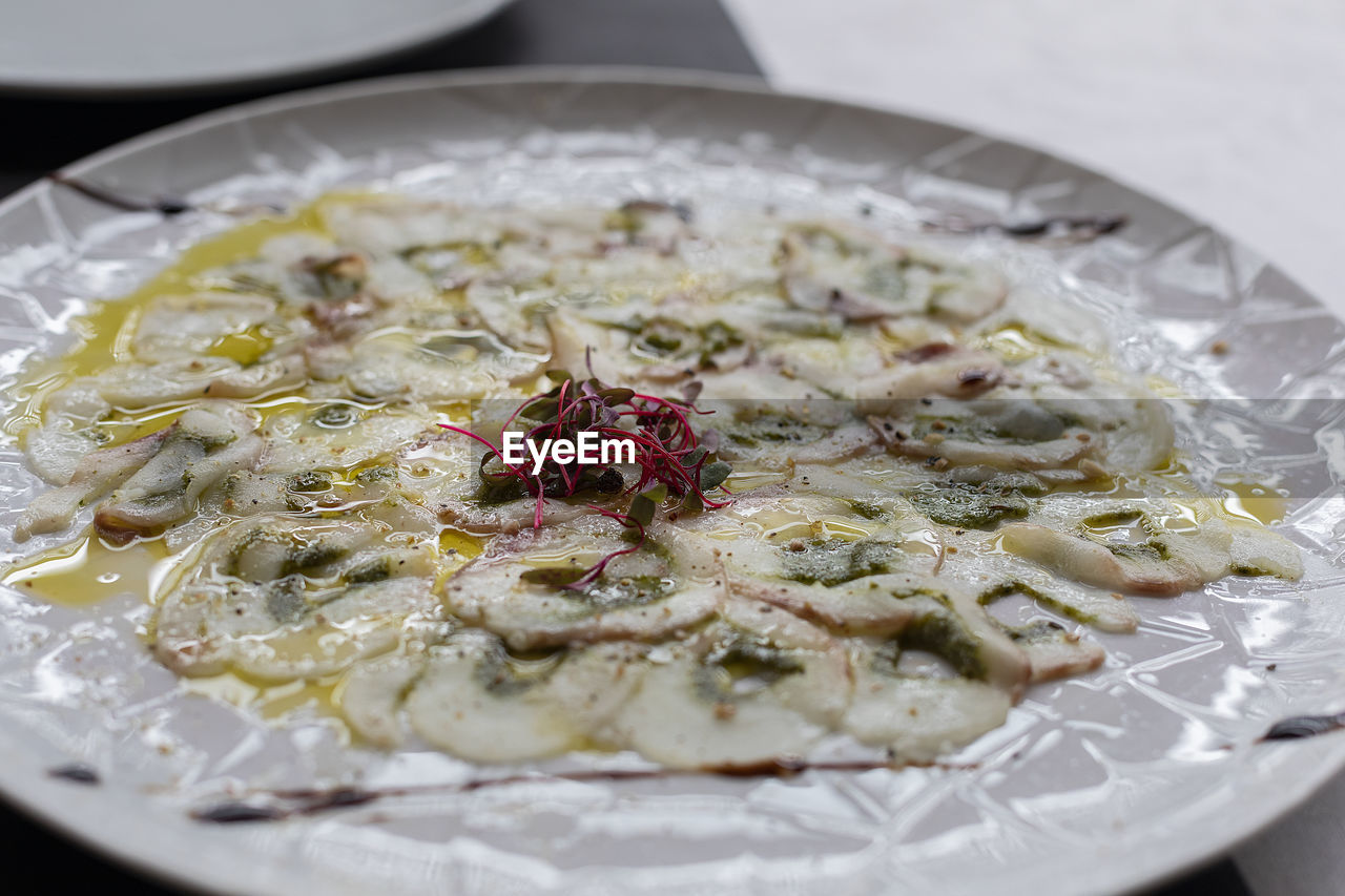 A plate of fish carpaccio. 