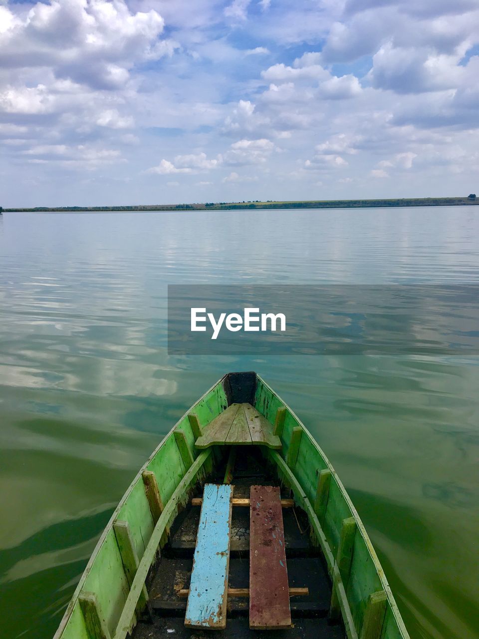 BOAT ON LAKE AGAINST SKY