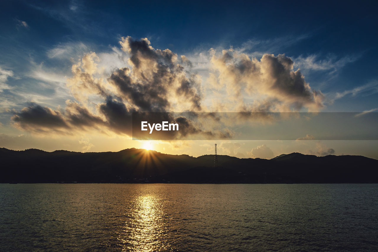 Scenic view of silhouette mountains against sky during sunset