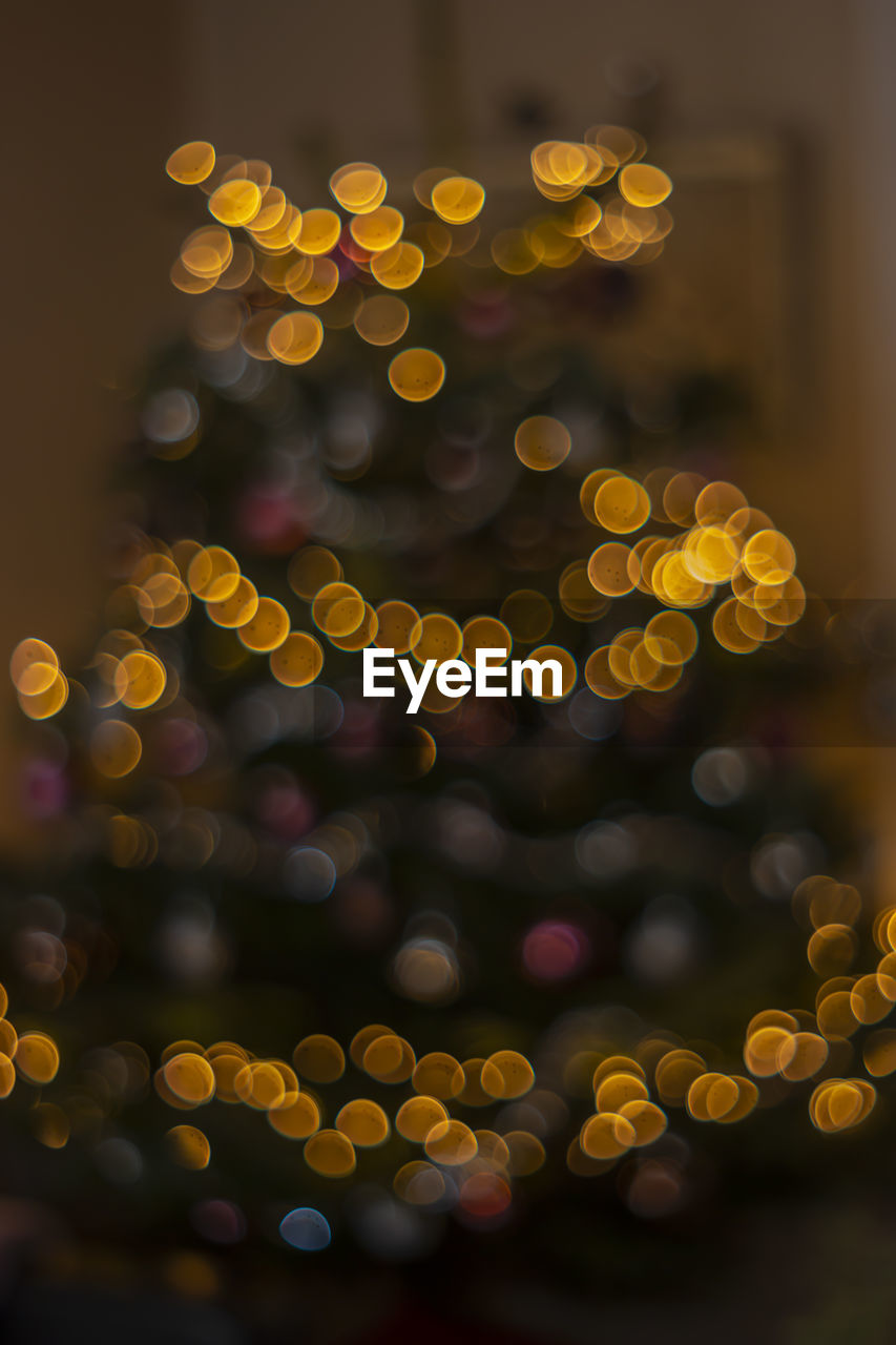 Defocused image of illuminated christmas tree