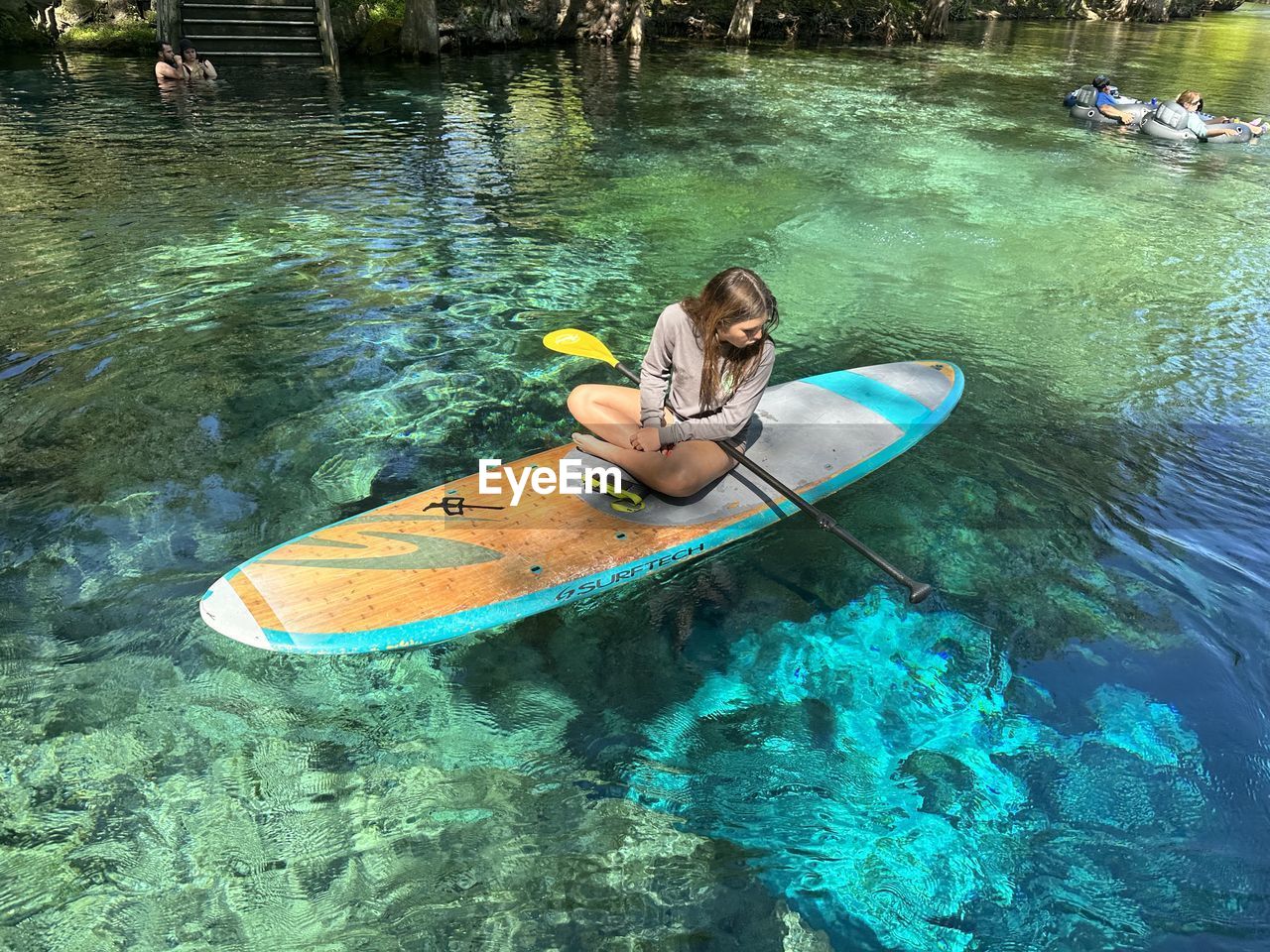 high angle view of woman kayaking in sea