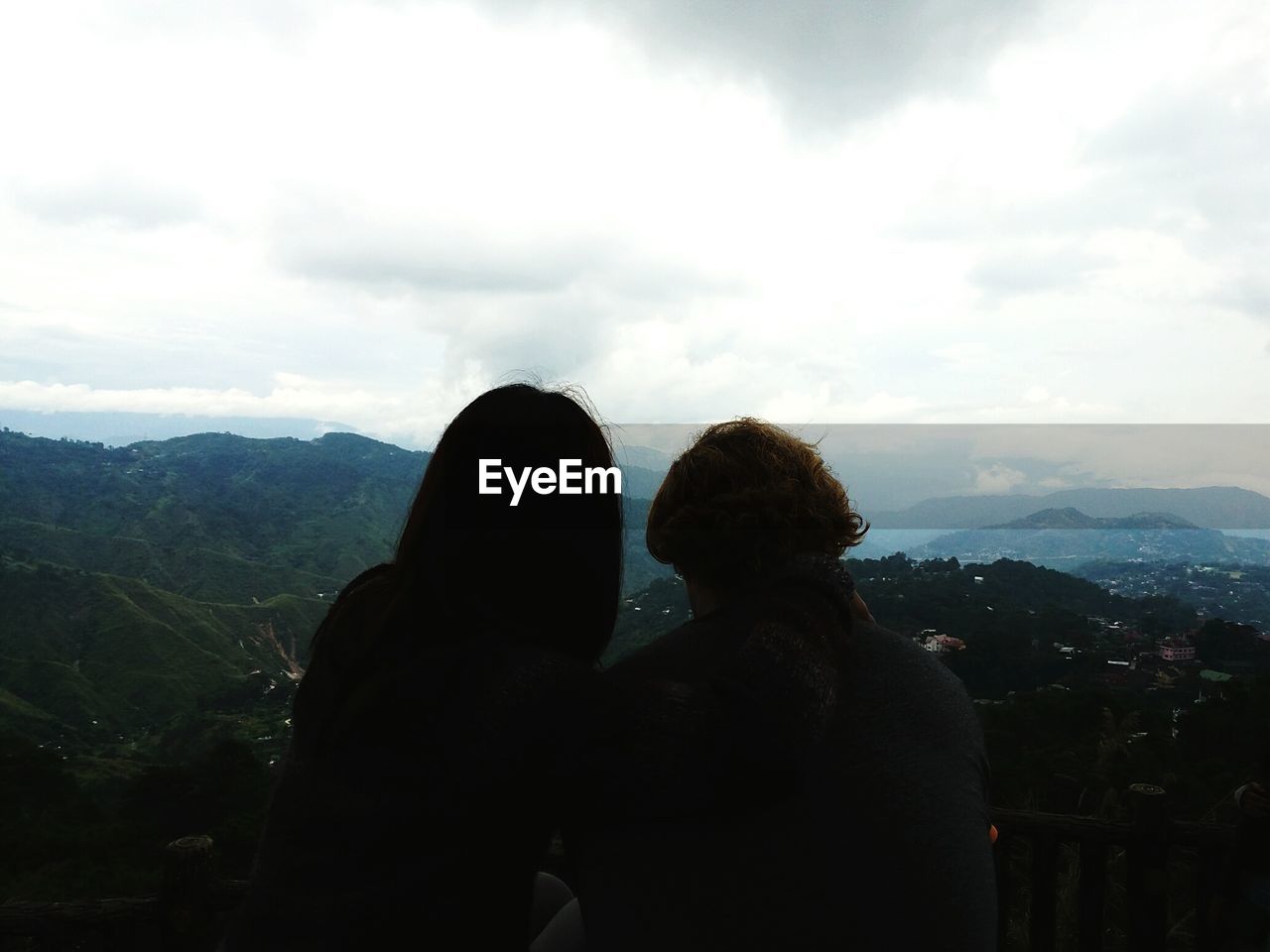 SCENIC VIEW OF MOUNTAINS AGAINST CLOUDY SKY